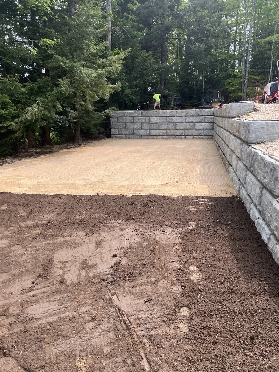 Compacted gravel building pad with a new segmental block retaining wall