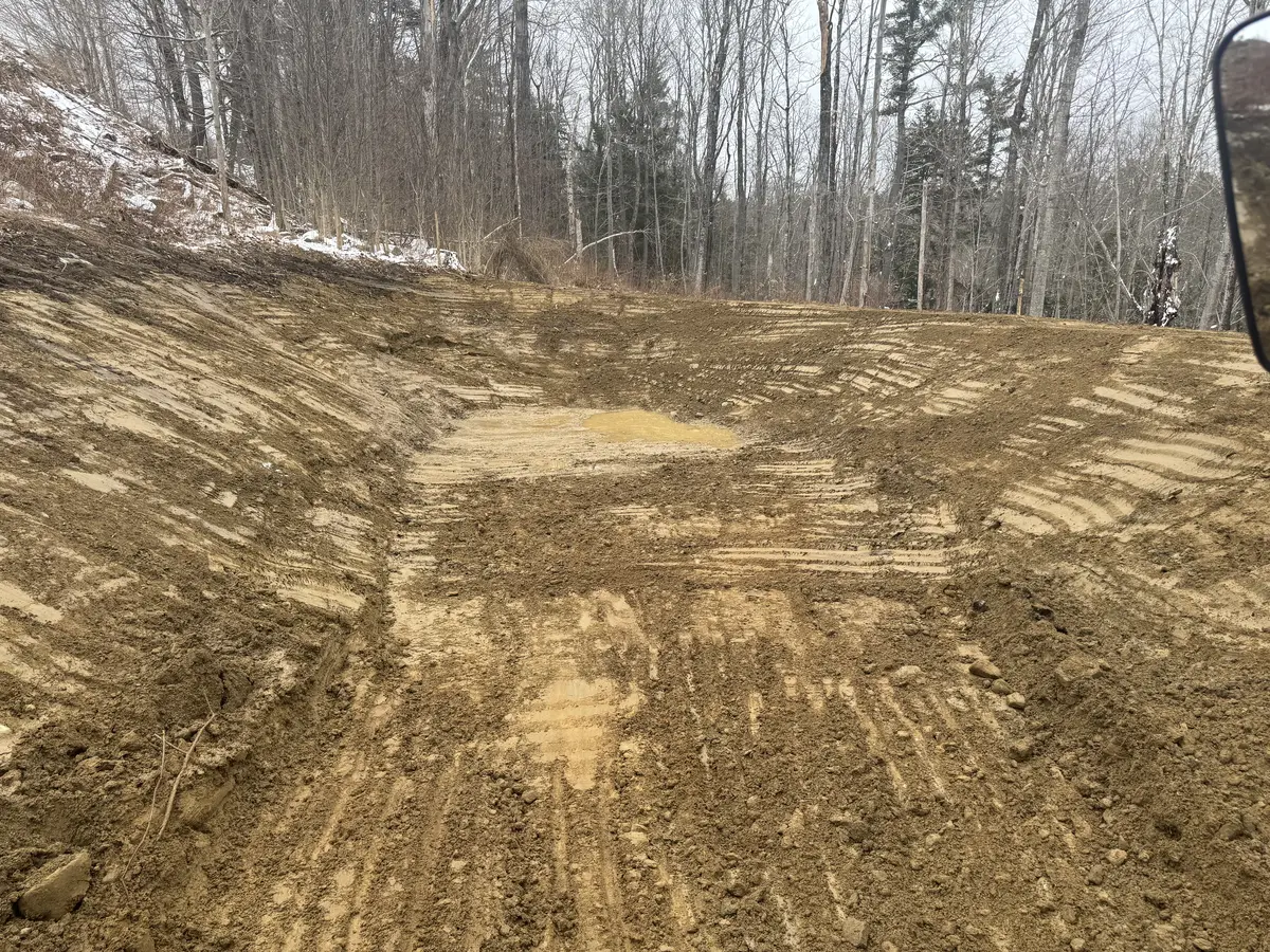 Graded earth basin taking shape during pond construction
