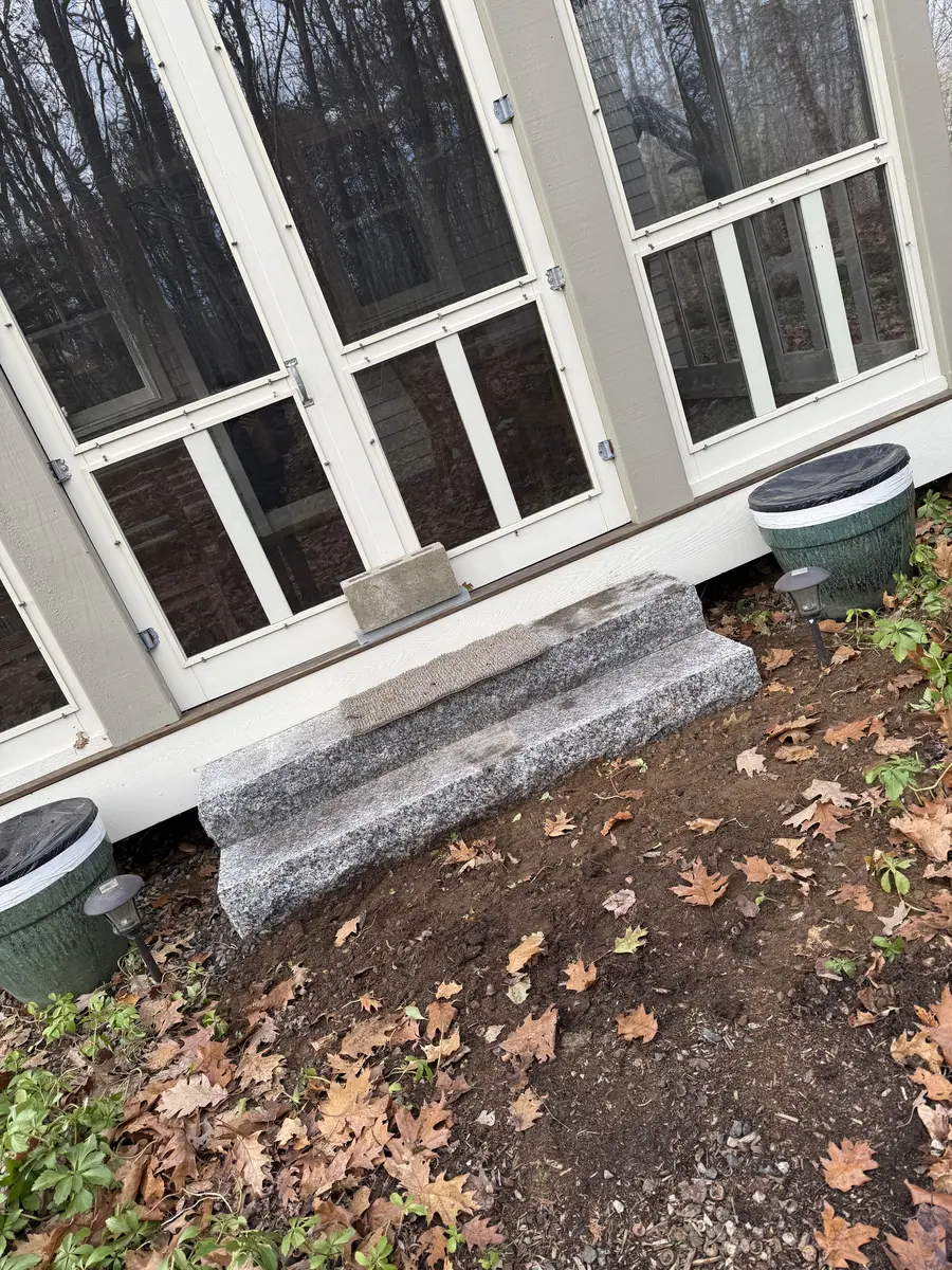 Granite slab step set at a screened porch entry