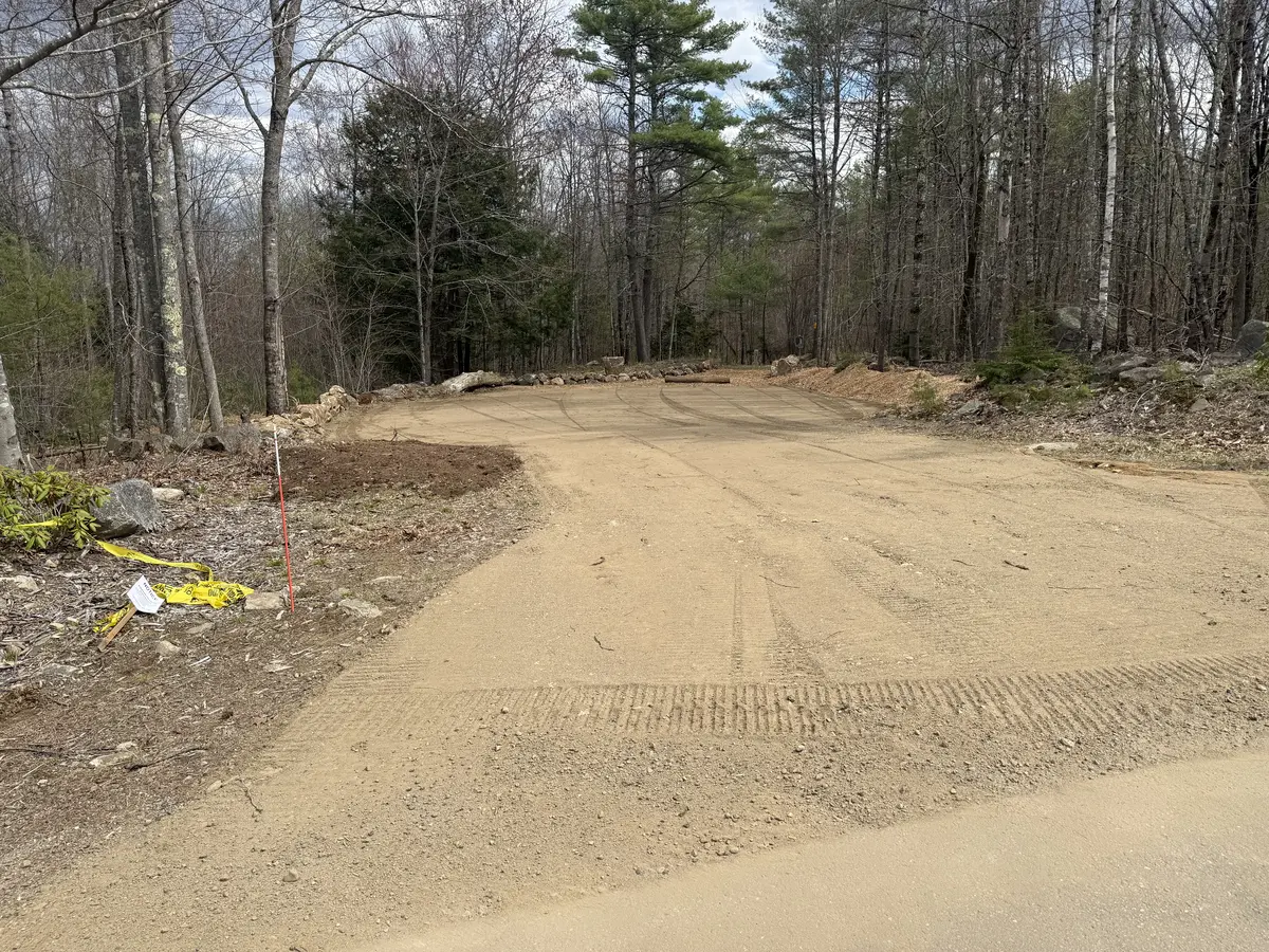 Compacted gravel drive with staked layout on a new building site