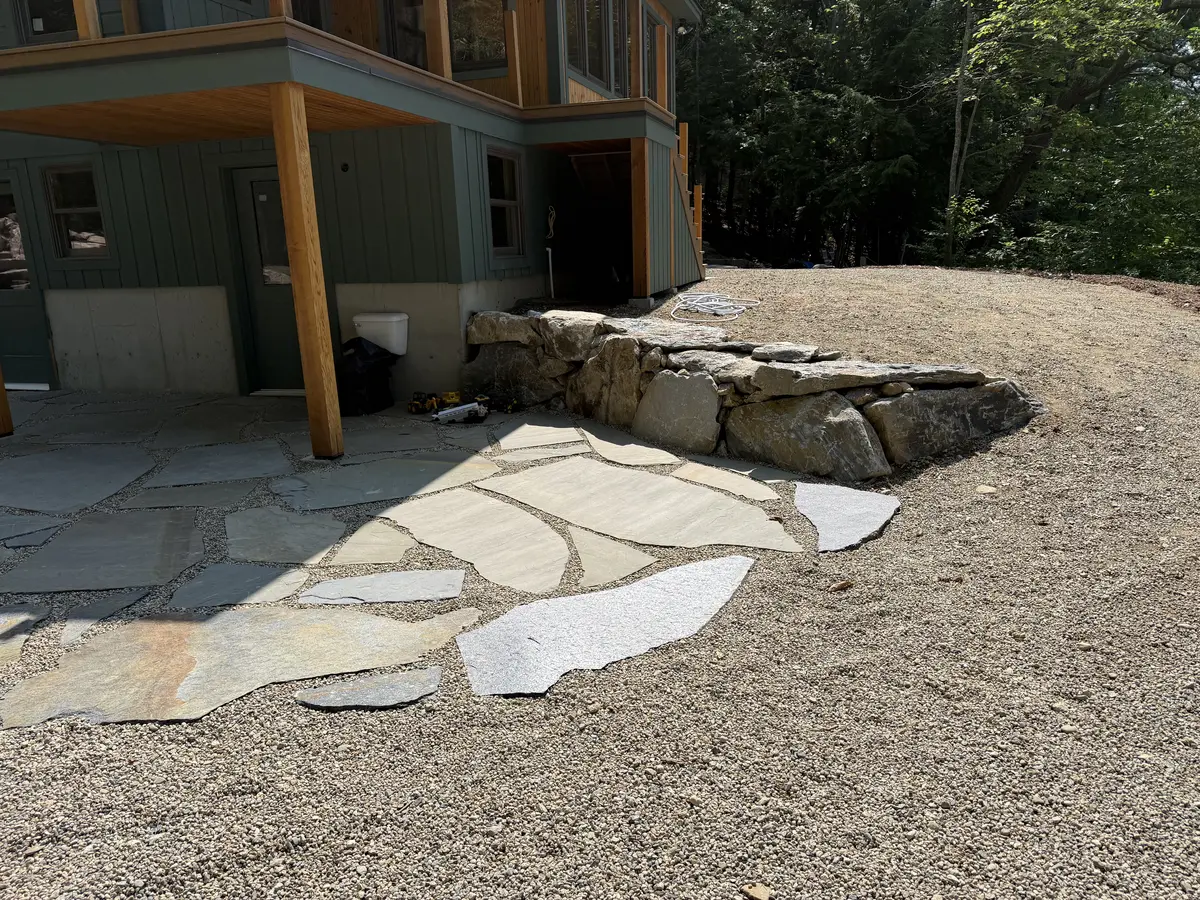 Natural flagstone patio set in stone dust beside a home