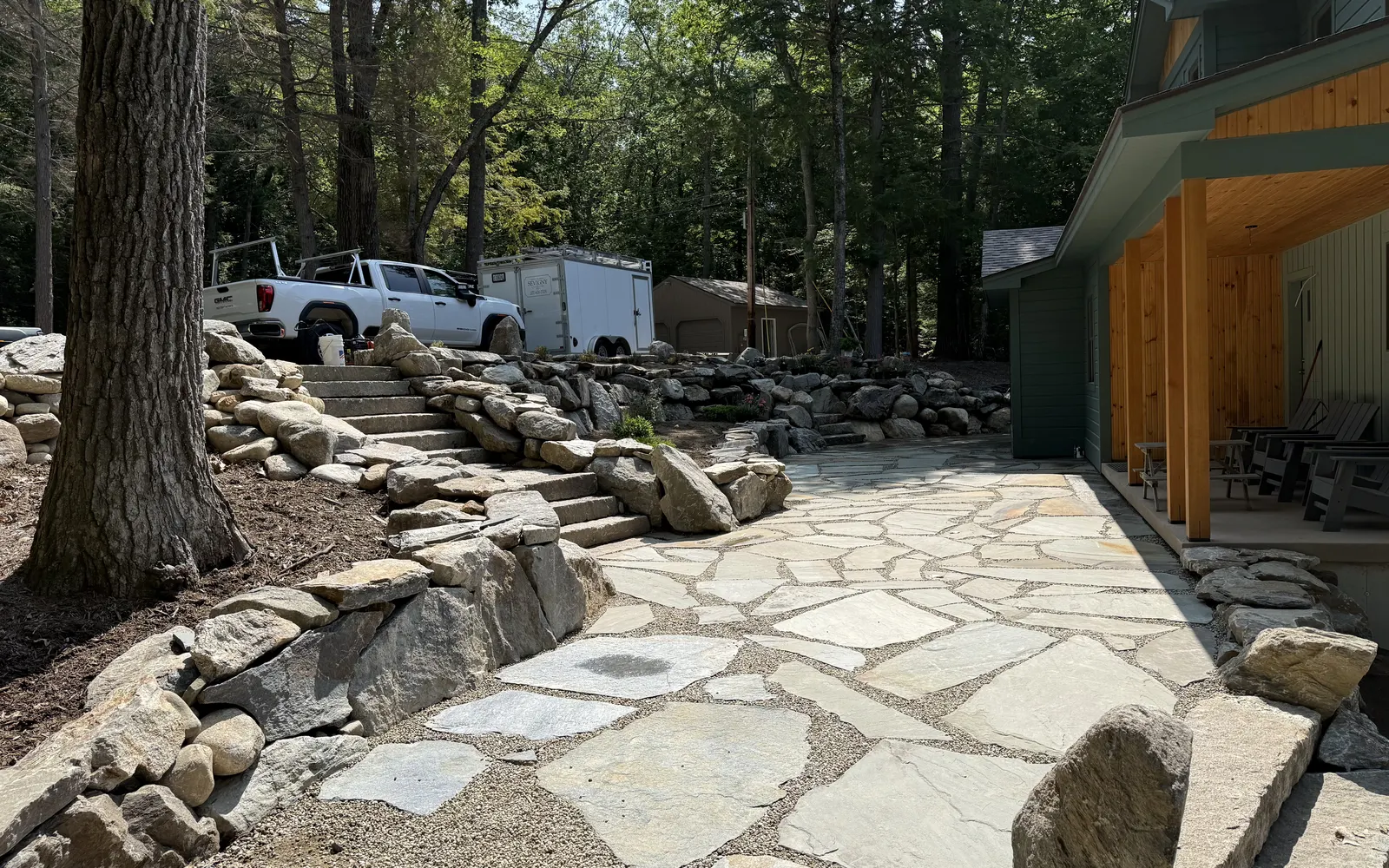 Finished flagstone patio and fieldstone walls at a southern Maine home